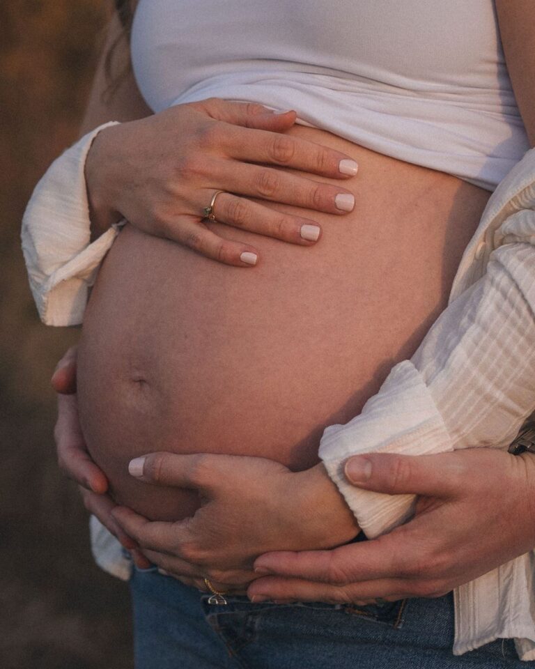 Expectant mother holding her belly